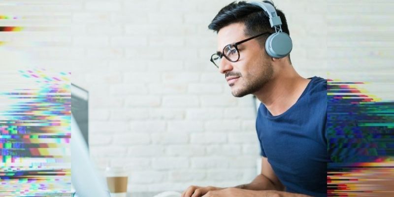 man with headphones and laptop